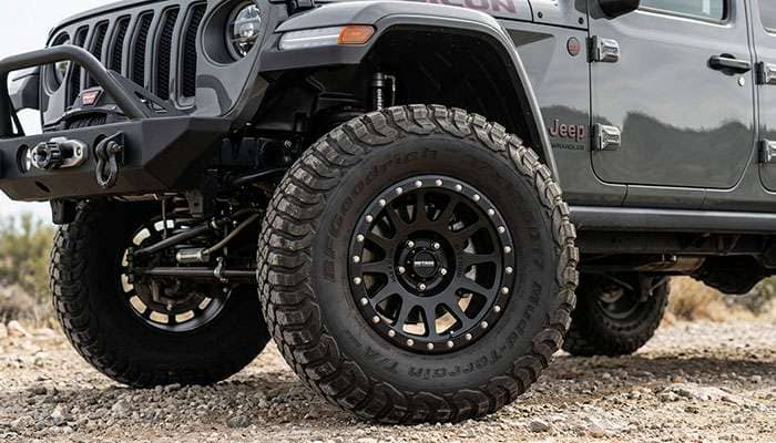 17 inch beadlock off-road wheel mounted on a modified Jeep showing the aggressive tread pattern and classic off-road wheel styling with beadlock ring