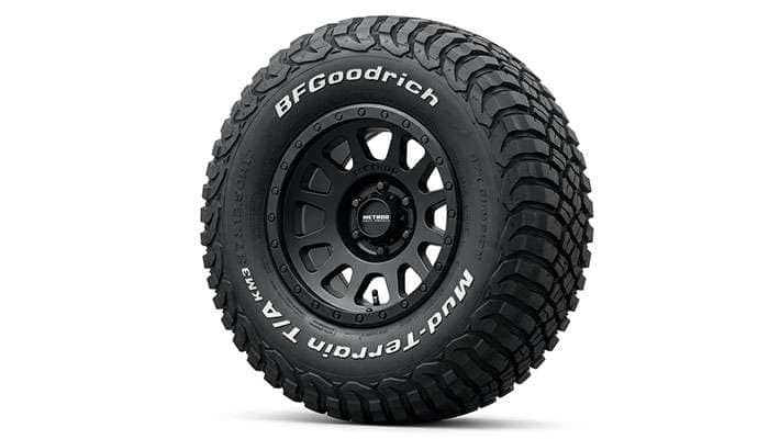 17-inch off-road wheel with a tall mud-terrain tire sidewall flexing over rocks
