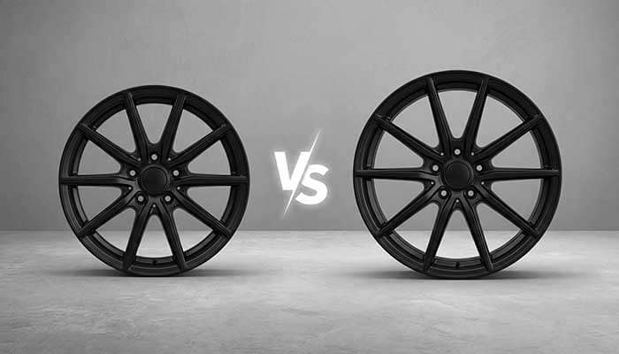Comparison of 17-inch and 20-inch black alloy wheels with a vs symbol between them on a textured background