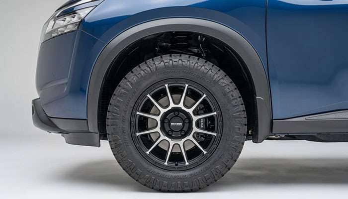 Close-up of a 2022 Nissan Pathfinder showcasing its aftermarket wheel and tire setup.