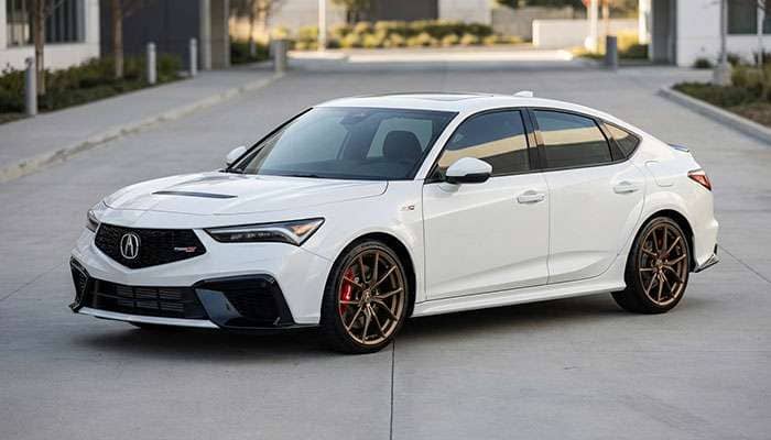 White 2024 Acura Integra Type S parked on a concrete road with bronze wheels and red brake calipers