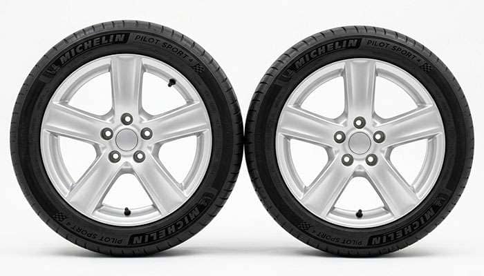 Two tires of different section width standing side by side for comparison