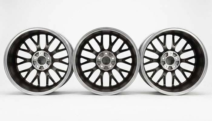 Three identical wheels mounted at positive, zero and negative offset to show how far each sits from the fender line
