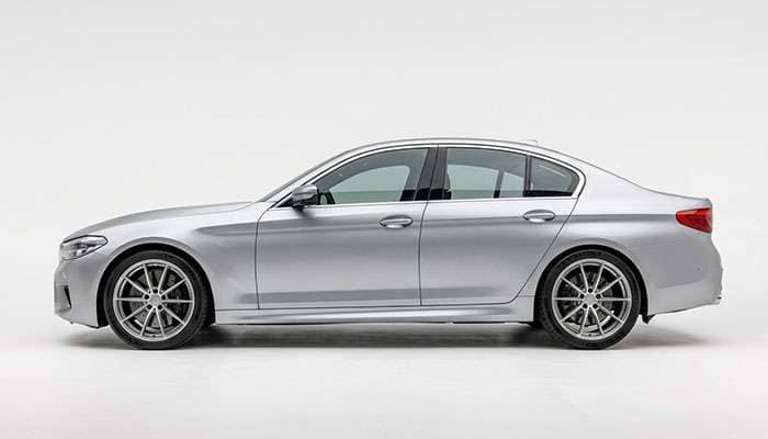 Rear wheel drive sports sedan with a narrower front wheel and wider rear wheel in a staggered setup