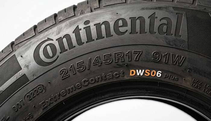 Close-up of a tire sidewall showing the 215/45R17 size marking with load index and speed rating service description