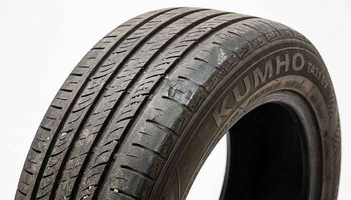 Worn 215/50R17 tire showing accelerated shoulder wear from carrying more load than its rating allows