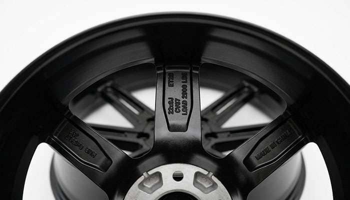 Inner spoke of an OE Replica Wheels CV67 22x9 gloss black wheel showing the cast load rating stamp