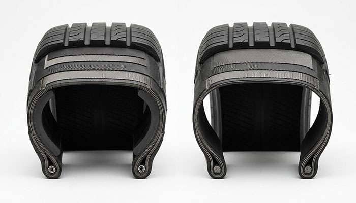 Cutaway comparison of a run-flat tire reinforced sidewall next to a standard tire sidewall on a clean white seamless backdrop
