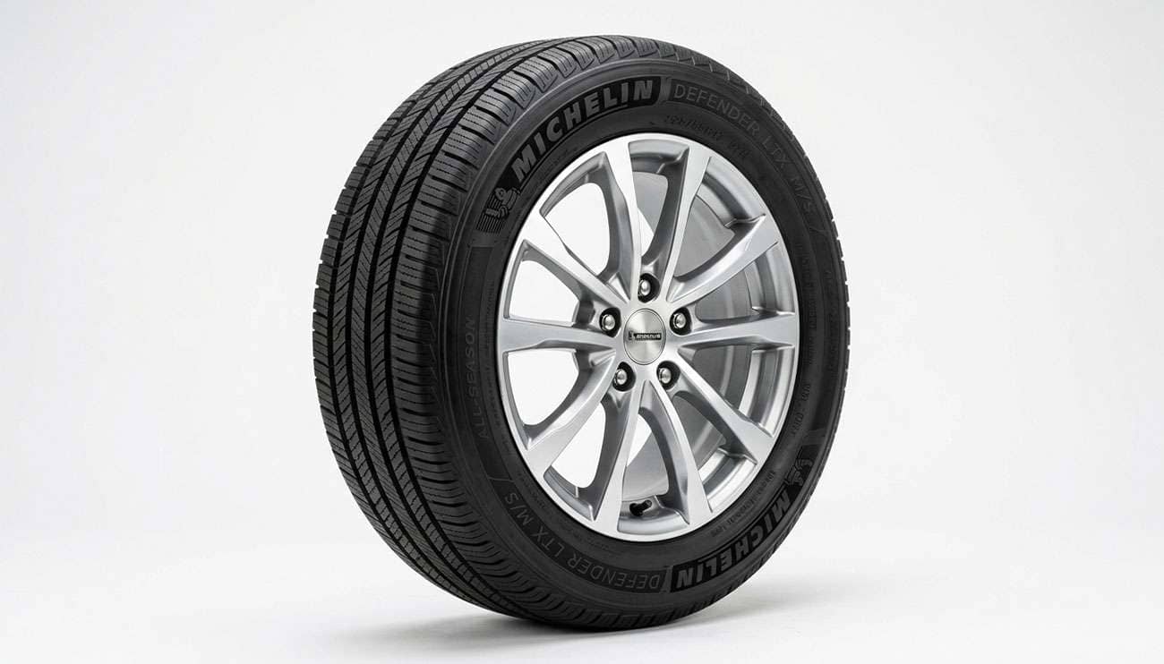A 225/55R17 all-season touring tire mounted on a machined-finish alloy wheel on a clean white studio background