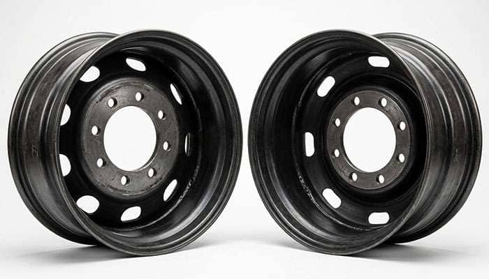 Two identical 22x10 wheels shown from behind at different offsets to compare mounting pad position