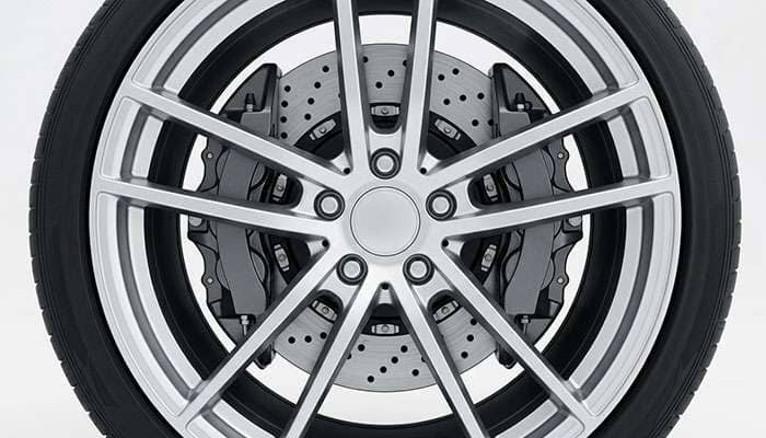 Cutaway view of an eighteen inch alloy wheel showing the large brake rotor and caliper clearance behind the spokes