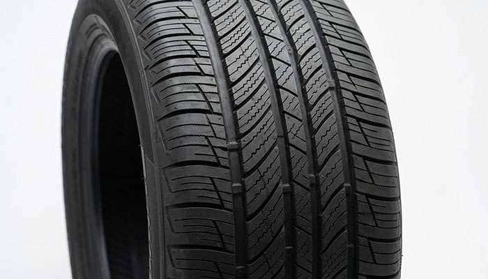 All-season 235/45R17 tire tread pattern showing circumferential grooves and full-depth siping
