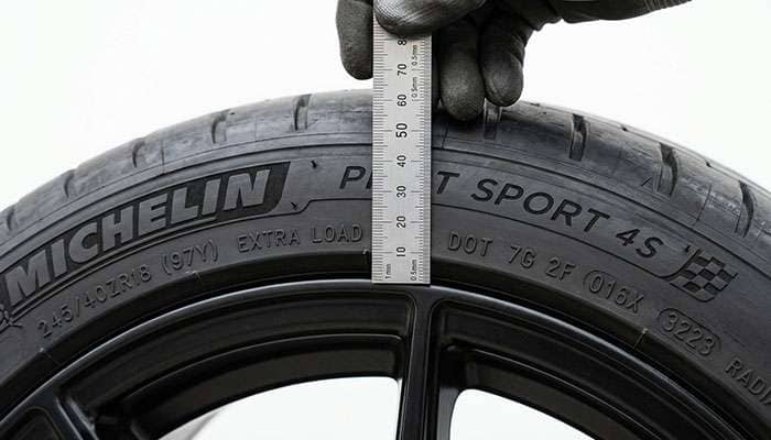Measuring the 98 millimeter sidewall height of a 245/40R18 tire from bead to tread