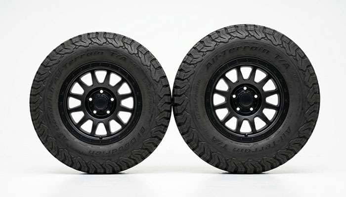 Two truck tires standing side by side showing the height and width difference between a 245/70R17 and a 265/70R17