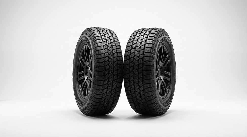 Comparison of 275 and 285 tire sizes showing different tread patterns and wheel designs with a versus symbol in the center