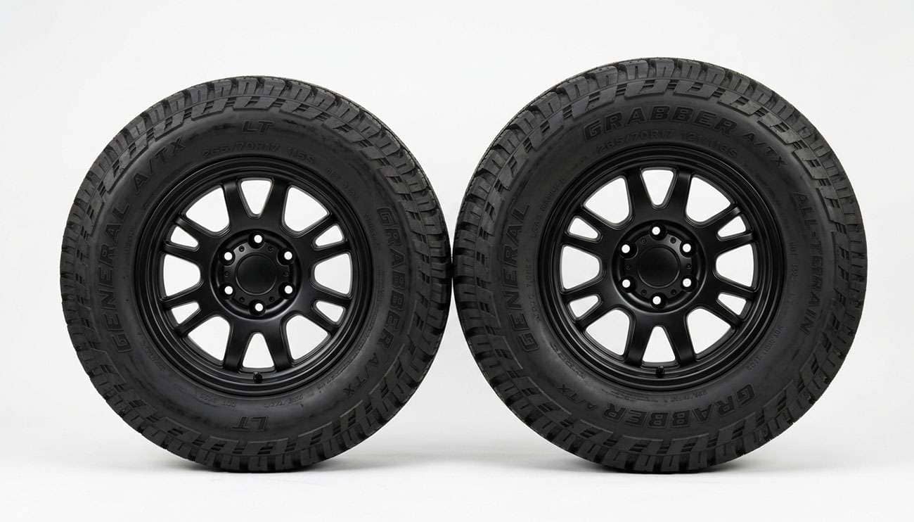 265/70R17 and 285/70R17 all-terrain truck tires standing side by side showing the difference in width and height