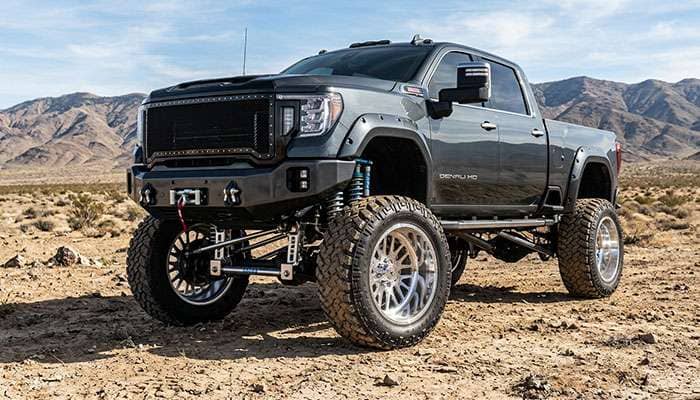 Lifted pickup truck fitted with 30 inch forged wheels and oversized off-road tires