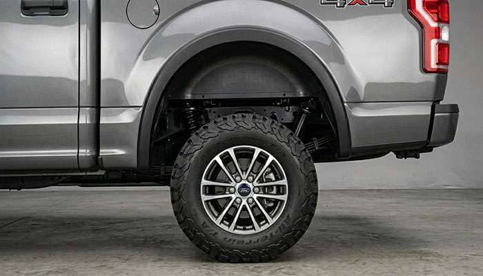 Stock pickup truck with 31 inch all-terrain tires showing a modest upgrade from factory tire size