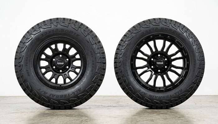 Side-by-side comparison of a 33-inch tire on a 17-inch wheel showing a tall 8-inch sidewall versus a 33-inch tire on a 20-inch wheel showing a shorter 6.5-inch sidewall on a clean white seamless studio backdrop