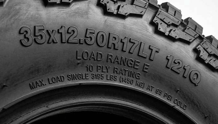Close-up of a 35-inch light truck tire sidewall showing the flotation size code, load index, and load range markings