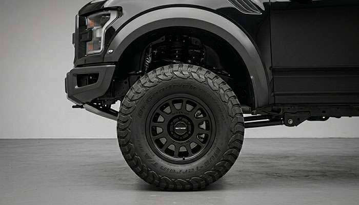 Lifted truck with 35 inch mud-terrain tires showing aggressive stance with proper lift kit clearance