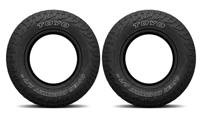 Toyo Open Country A/T III LT35x12.50R20 Load Range E and Load Range F tires side by side showing the sidewall load markings