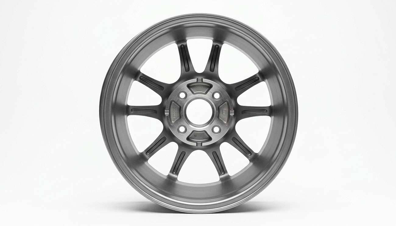 Back of a four-lug wheel showing the bolt circle and center bore, photographed on a clean white backdrop