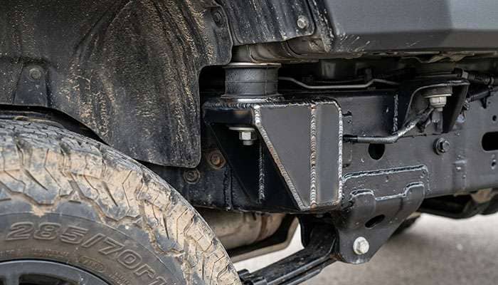Front body mount behind the front tire of a 5th gen Toyota 4Runner after a body mount chop with a welded cover plate
