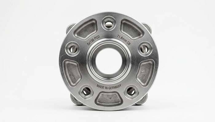 Close-up of a five-lug wheel hub showing the 5x130 bolt circle on a clean white studio backdrop