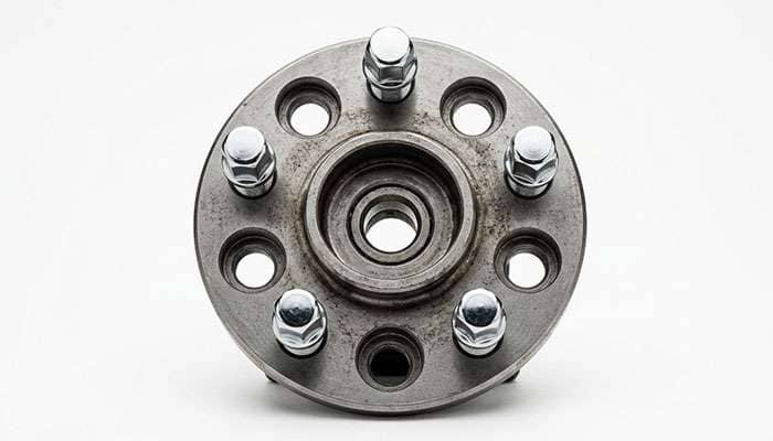 Close-up of a classic five-lug wheel hub showing the 5x4.75 bolt pattern