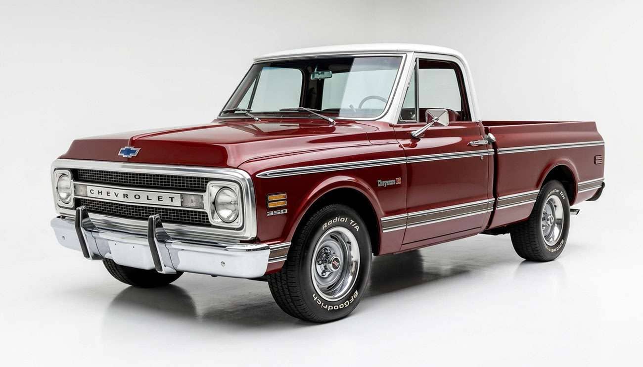 Classic American pickup truck with steel wheels on a clean white studio background