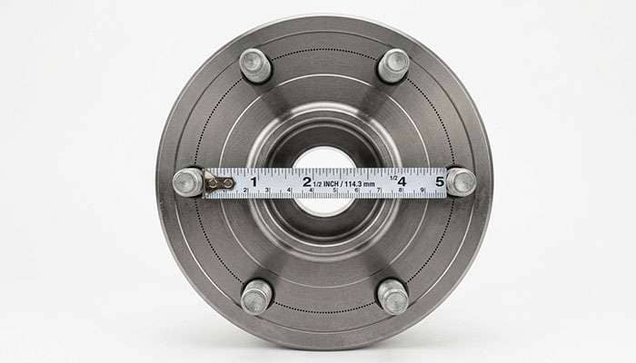 Diagram showing how to measure a six lug bolt pattern from the center of one stud straight across to the center of the opposite stud