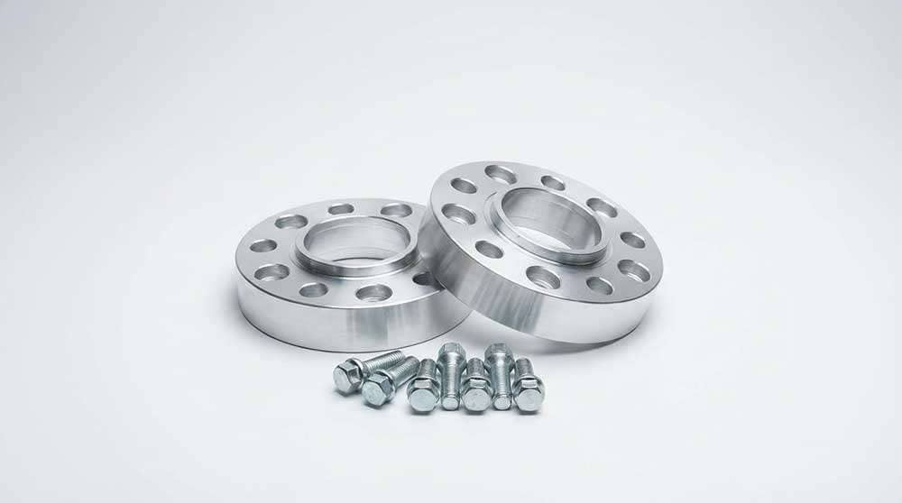 Two silver 2-inch 8-lug wheel adapters with bolts and a red and white tube in front on a white background.