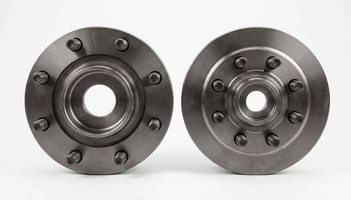 Two heavy-duty truck hubs side by side comparing an eight-stud 210mm bolt circle against a narrower eight-stud 180mm bolt circle