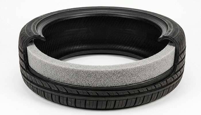 Interior of a tire showing the strip of acoustic foam bonded to the inner surface beneath the tread