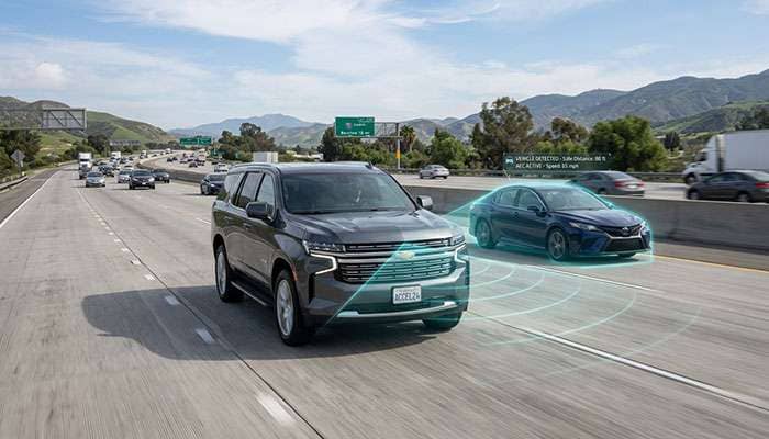 Large SUV with adaptive cruise control engaged following traffic on interstate highway showing sensor coverage