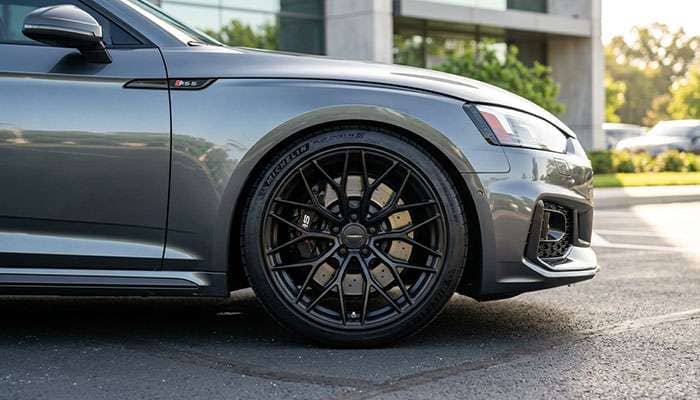 Aftermarket alloy wheel with TPMS sensor installed showing proper fitment on a passenger vehicle