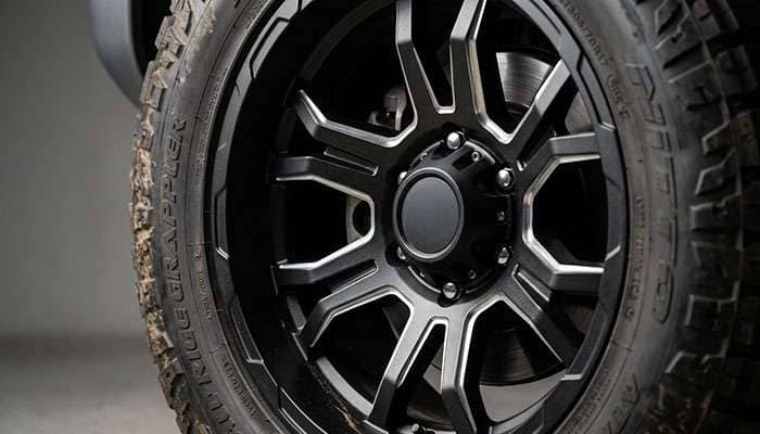 Detail of aggressive truck wheel design with milled accents and matte black finish