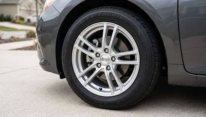 All-season touring tire mounted on a sedan wheel showing clean bead seal at the rim flange