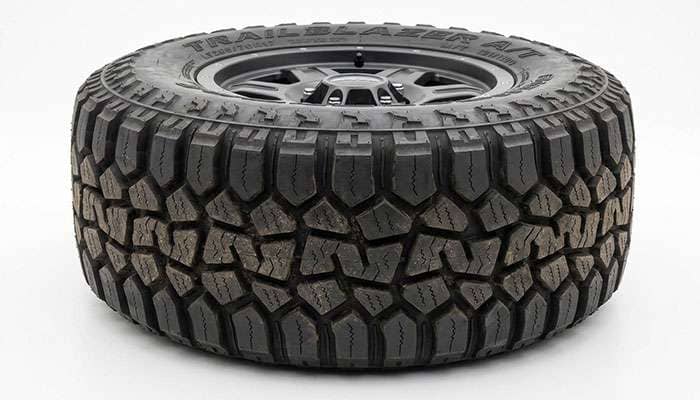 All-terrain tire tread pattern with aggressive shoulder blocks and siping