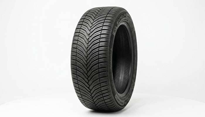 All-weather all-season tire with directional V-shaped tread and a Three-Peak Mountain Snowflake marking on a clean white seamless studio backdrop
