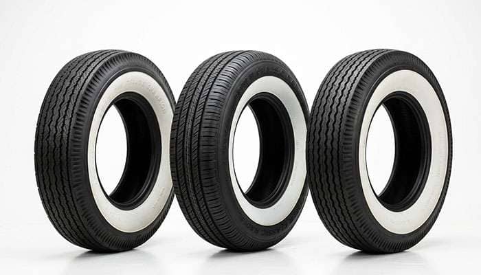 Three antique car tires on a clean white surface showing bias ply radial and bias look radial construction differences