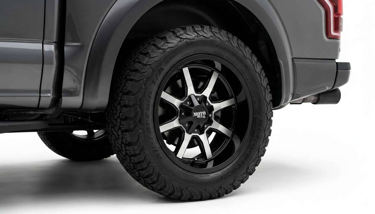 Moto Metal MO970 wheel in gloss black with machined face mounted on a pickup truck showing the deep dish profile and angular spoke design