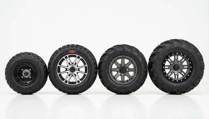 Four ATV wheels in different sizes representing youth sport utility and UTV categories on a clean white studio surface