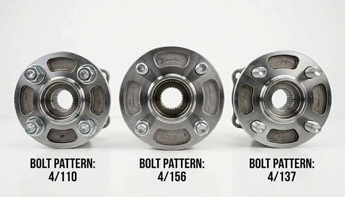 Three ATV wheel hubs showing different bolt patterns 3-lug 4-lug and 5-lug configurations on a clean white surface