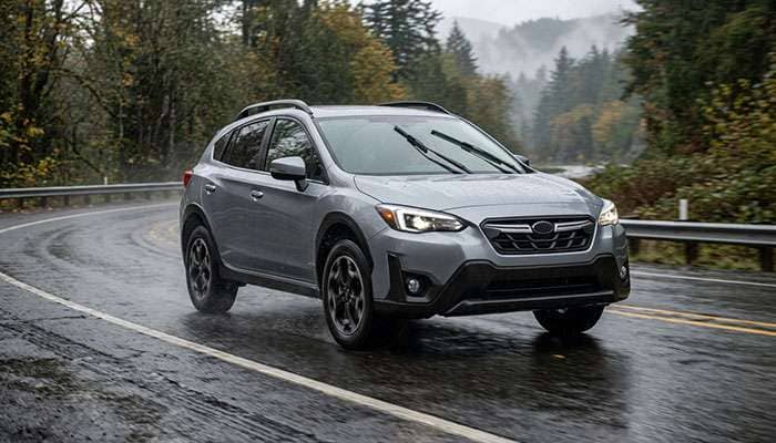 All-wheel-drive crossover on a wet road with four matching 235/60R18 tires