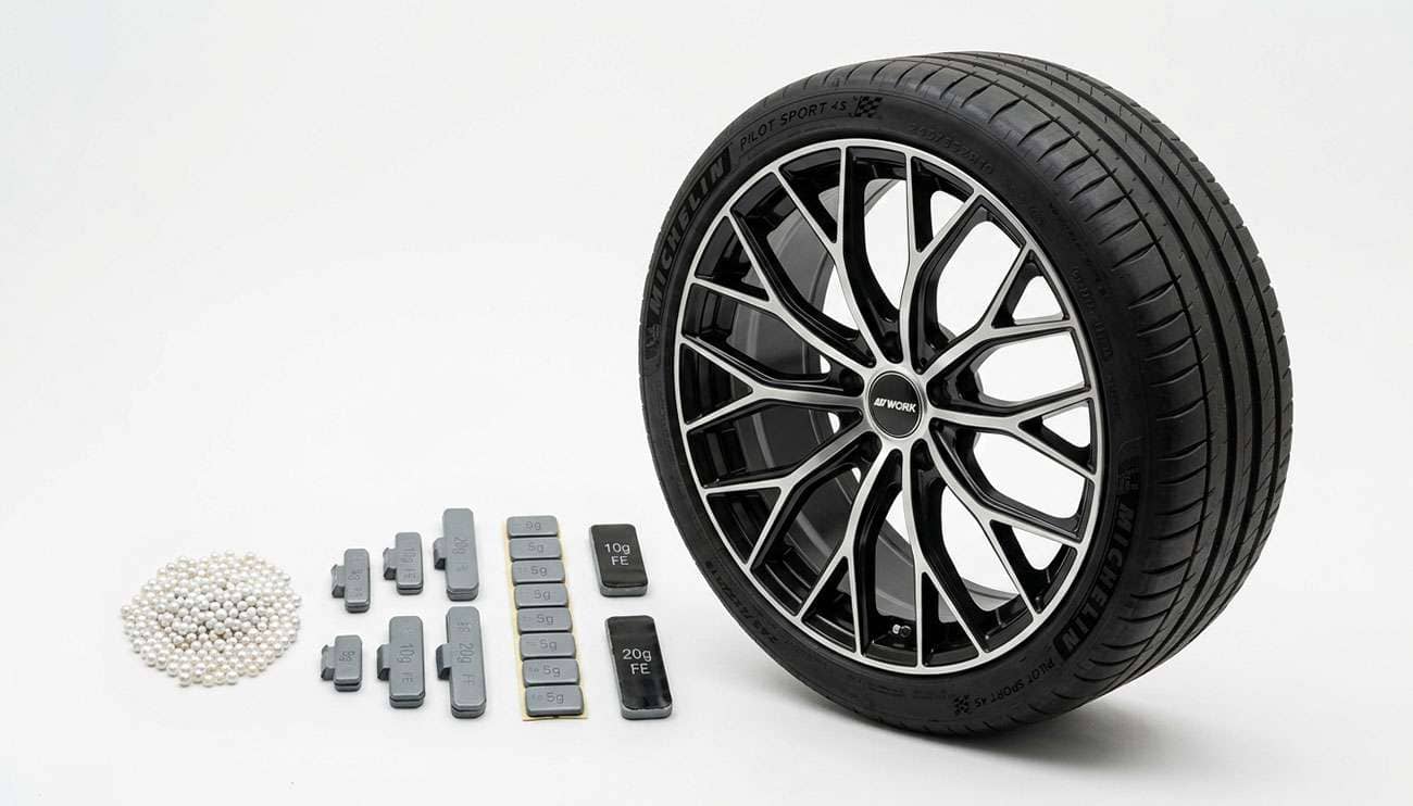 Tire balancing beads next to clip-on and adhesive wheel weights comparison