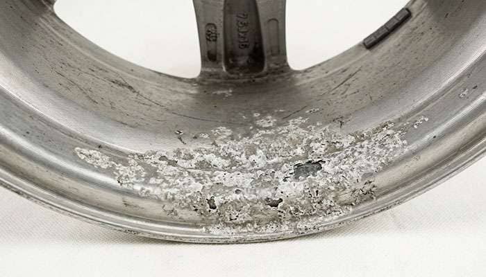 close-up of white chalky aluminum oxidation crusted on the bead seat of a wheel where the tire bead should seal