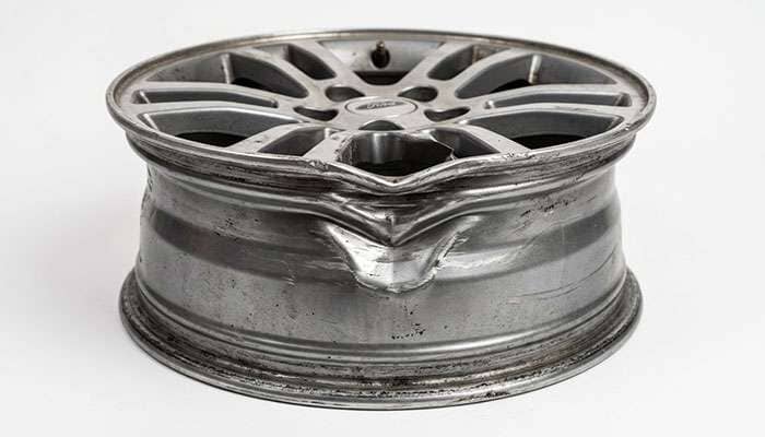 Bent inner barrel on an alloy wheel after a pothole impact