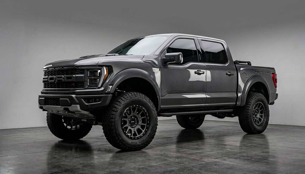 Lifted truck with aggressive off-road wheels in rocky desert terrain showing rugged off-road build